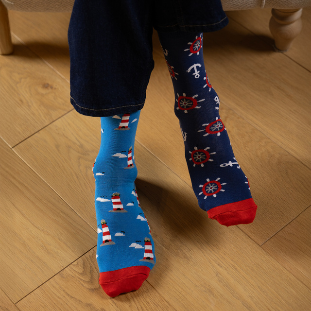Colorful mismatched SOXO GOOD STUFF socks lighthouse
